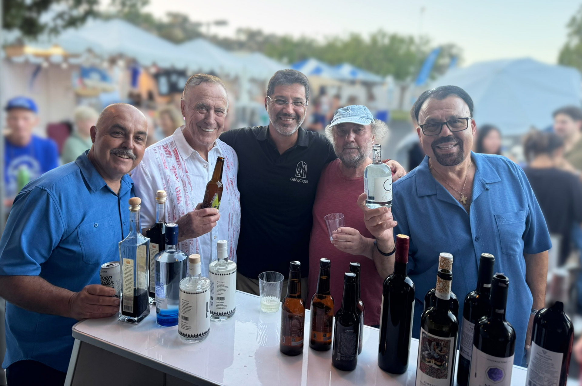 At the Cardiff-by-the-Sea Greek Festival: The Olympians, a Southern California Greek band, together with Yannis, owner of the Greek restaurant Tastes of Greece in Laguna Niguel, at the Greecious booth.