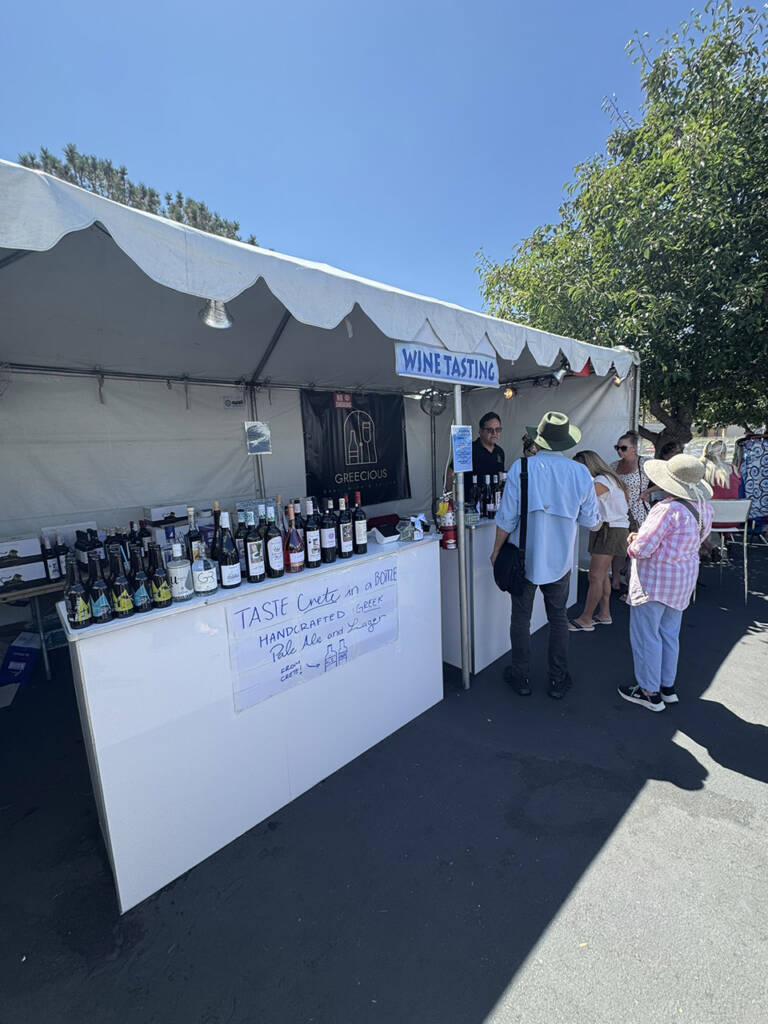 Sales Manager Michalis Pavlidis welcoming visitors at the Greecious booth during the Cardiff-by-the-Sea Greek Festival in San Diego.